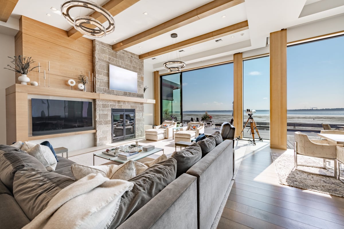 Luxury modern living room with floor to ceiling windows and warm evening light